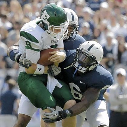 Penn State linebackers Gerald Hodges and Khairi Fortt tackle Eastern Michigan quarterback Alex Gillett  during the second quarter of a NCAA college football game in State College, Pa.