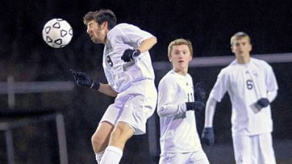 Quaker Valley's Dante Piccolo heads the ball from midfield against General McLane Tuesday.