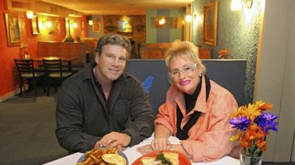 Lenny Radziewicz and Penny Folino with their pretzel burger, left, and a Mediterranean platter at their restaurant, Center Plate.
