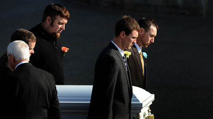 Pallbearers carry the casket of Maddox Derkosh, the 2-year-old who died after falling into the African painted dog exhibit at the Pittsburgh Zoo, into St. Bernard Church in Mt. Lebanon this morning.
