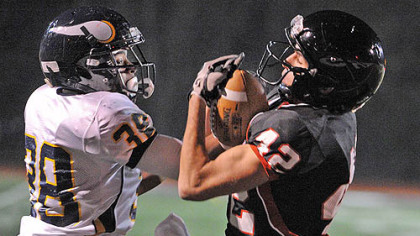 Central Catholic cornerback Joe Tindal, left, battles for the ball with Upper St. Clair receiver Tim Witenske in the first half of the WPIAL quarterfinal Friday at Baldwin High School.