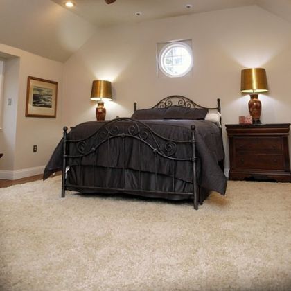 To expand the master bedroom the ceiling was raised from 8 to 12 feet and three of the four walls were moved. The back wall was moved out 5 feet. A new round window in the side wall "lets the moon shine in my eyes," Mr. Wizig says.