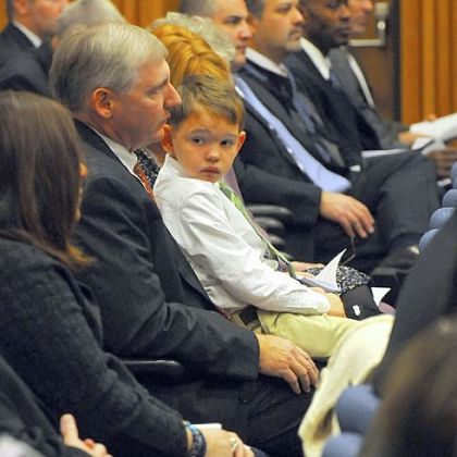 Joey O'Donnell, 8, sits on his father's lap during the Law Enforcement Agency Directors awards ceremony at the University of Pittsburgh's Barco Law Building on Friday. Kevin O'Donnell, Joey's father, is a special agent with the Internal Revenue Service in the Criminal Investigation Division.