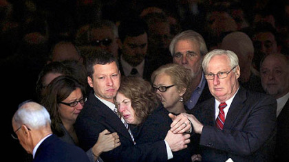 Jason and Elizabeth Derkosh, the parents of Maddox Derkosh, watch as pallbearers carry their 2-year-old son's casket out of St. Bernard Church in Mt. Lebanon on Friday.