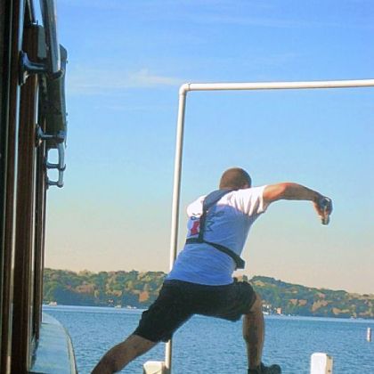 Mail is delivered from a moving boat by agile crew members who leap on and off the lake's piers in Lake Geneva, Wis.