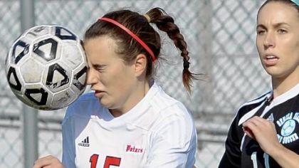 Peters Township's Abigail LaVigna heads ball against Seneca Valley in a PIAA quarterfinals match at Chartiers Valley High School.