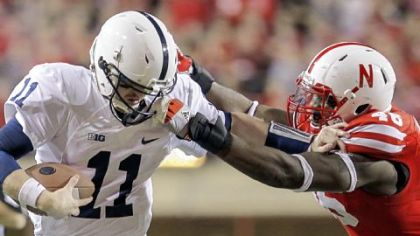 Nebraska's Eric Martin, right, snags the facemask of Penn State quarterback Matt McGloin Saturday in Lincoln, Neb.
