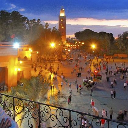 Jemaa el Fna with Koutoubia Mosque at sunset.