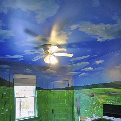 A mural with blue skies and fluffy clouds fill the 14- by 12-foot ceiling in one of the bedrooms.
