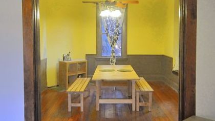 Pocket doors separate the living room and the 15- by 12-foot dining room, which has wood wainscoting and a built-in window seat.