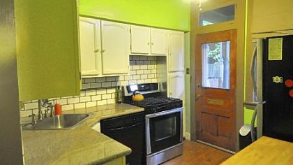The kitchen features granite countertops, a tile backsplash and stainless-steel appliances.