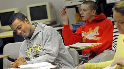 Delvon Randall, a junior at Boyce Campus Middle College High School, takes notes during class.