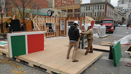 Pre-assembled sections are moved into place for the assembly of "Santa's House" in Market Square.