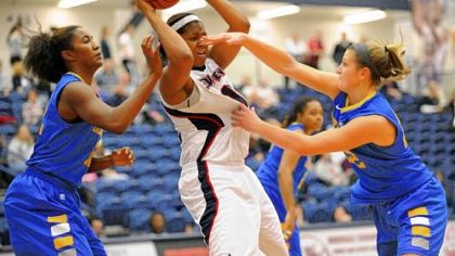 Delaware's Lauren Carra, right, defends Duquesne's Wumi Agunbiade Wednesday at Palumbo Center. Agunbiade had 17 points and 12 rebounds.