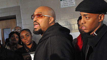 Latonya Green, left, , mother of Leon Ford, who was shot by Pittsburgh Police during a traffic stop November 11, 2012, listens to Leon's father, Leon Ford, Sr.  during a press conference at which the family called upon the city and the police to allow them to see him in the hospital. At right is Leon's older brother, Mondale Ford.