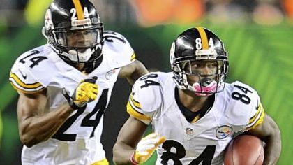 Antonio Brown picks up good yardage on punt return as Ike Taylor blocks for him against the Bengals Sunday at Paul Brown Stadium in Cincinnati.