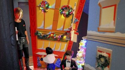 Lisa Zwirn, visual manager for Macy's Downtown, makes last-minute checks of the four holiday-themed windows. The windows, with two Pittsburgh-themed displays, will be unveiled Friday.