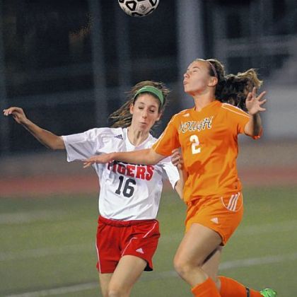 Moon defender Sydney Schipani, left, and Yough forward Hannah Ponitz fight for possesion Oct. 24 in a WPIAL Class AA quarterfinal at Chartiers Valley High School.