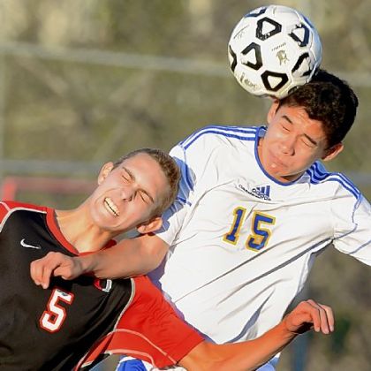 Upper St. Clair's Kevin Muck, left, battles with Canon-McMillan's Ivan Viveros during a PIAA Class AAA quarterfinal match Saturday at Chartiers Valley High School.