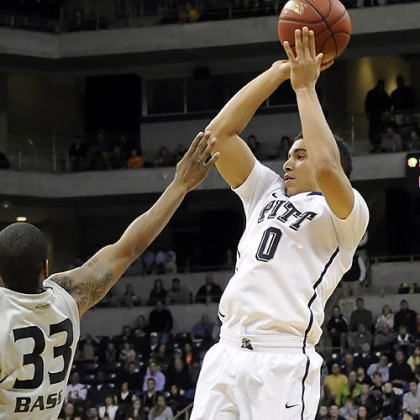 Pitt's James Robinson puts up a shot against Oakland's Ryan Bass in the second half.