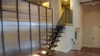 The contemporary living spaces showcase restored and recreated woodwork from Allied Millwork.