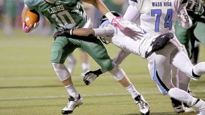 South Fayette's Zach Challingsworth runs with the ball under pressure from Washington's  Mijerean Witcher Friday.
