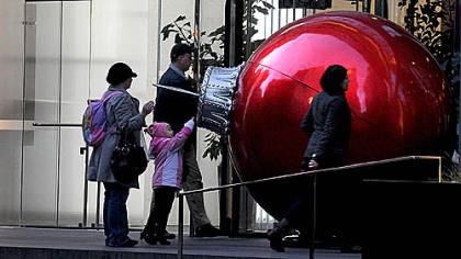 A large red ornament  greets commuters in front of the K&L Gates Center, Downtown, on the morning of Light Up Night.