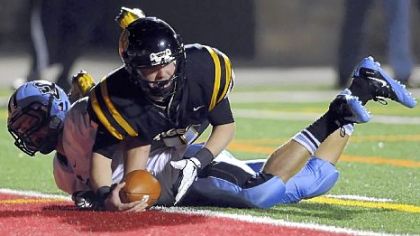 North Allegheny quarterback Mack Leftwich dives into the end zone Friday night for a touchdown against Seneca Valley's Benjamin Hodges.