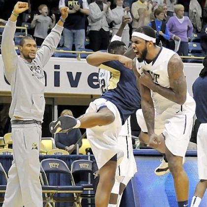 Pitt's J.J. Moore, right, celebrates the Panthers' 72-62 comeback win against Oakland in overtime Saturday at Petersen Events Center.