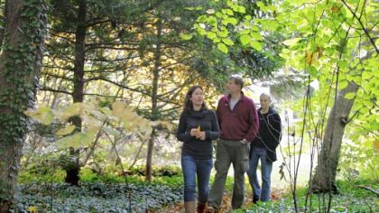Nicole Juday, left, Mark Sellers, center, and Claudia Levy tour the grounds around Awbury Arboretum in the Germantown section of Philadelphia.