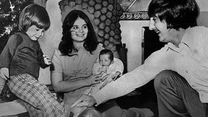 Days after the game in 1972, Ben Baker kicks the Immaculate Reception ball as his father, Jim Baker, holds and his mother and baby brother watch.