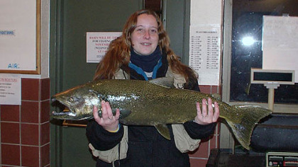 Sarah Crawford of West Mifflin shows off the chinook salmon she reeled in from Walnut Creek in Erie County.