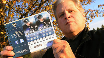 Ron Valerino, longtime Pens season ticket holder, flashes his tickets for the 2012-13 season. The question lingers: Will he ever get to use them?