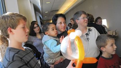 Landon Whitewood waits to enter Family Court on Saturday with his adoptive parents, Susan Whitewood, center, and Deb Whitewood, center right. At far left is his new cousin Parker Boyd, 12, and at far right is Parker's brother Cole, 8.