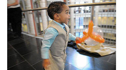 Landon Whitewood, 20 months, runs through a hallway at Family Court, Downtown, while waiting for his adoption hearing on Saturday.