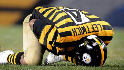 Steelers quarterback Byron Leftwich holds his left shoulder after getting sacked by Ravens safety James Ihedigbo late in the fourth quarter.