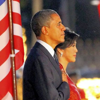 President Barack Obama and Thai Prime Minister Yingluck Shinawatra listen to national anthems Sunday during a welcome ceremony in Bangkok.