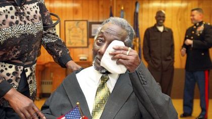 Lenel Moore, 87, wipes tears away after he is awarded his Congressional Gold Medal during a surprise ceremony Saturday at Veterans of Foreign Wars Post 943 in Ashtabula, Ohio. Congress authorized the gold medals in June for those who served as the first African-American Marines during World War II. Blacks were allowed to enlist in the Marines after President Franklin D. Roosevelt issued an executive order mandating enlistment regardless of race in 1942. They trained at a segregated base at Monford Point, N.C.