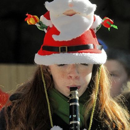 Maggie Behring, an 8th-grader at St. Ursula School in Hampton, plays the clarinet during the dedication of the creche at U.S. Steel Plaza, Downtown, on Friday.