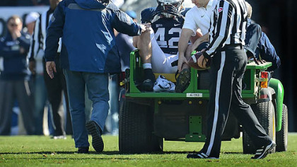 Penn State linebacker Michael Mauti clutches his helmet after injuring his left knee in the first half against Indiana at Beaver Stadium, State College on Nov. 17.