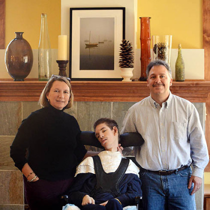 Lisa and Frank Falcione with their son Andy in the family room of their new home in Marshall.