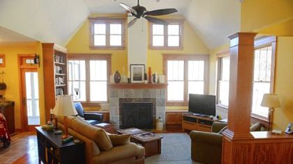 Lisa Falcione based the look of the family room on a photo she saw in a library book. The fireplace faced in slate and quartzite came from Hearth & Home.