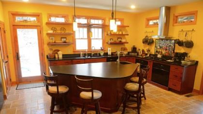The color and open shelving of the kitchen is similar to the Falcione's old house in Lakewood, Ohio.