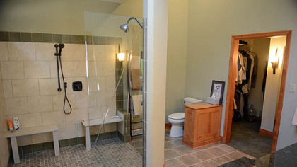 The master bathroom has a 6 1/2- by 6 1/2-foot shower with room for Andy Falcione, his wheelchair and a helper. The etched glass door is by Emerald Art Glass.