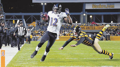 The Ravens' Jacoby Jones runs into the end zone on a punt return as the Steelers' Drew Butler tries to make the tackle in the first quarter at Heinz Field.