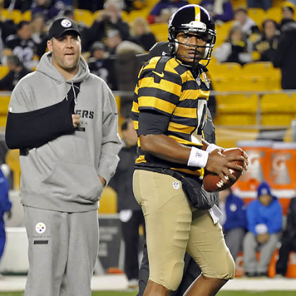 Steelers quarterback Byron Leftwich warms up as injured Ben Roethlisberger looks on. Leftwich wasted no time scoring the game's first touchdown.