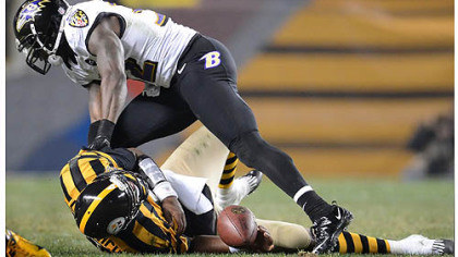Quarterback Byron Leftwich holds his left shoulder after getting sacked Sunday by Ravens safety James Ihedigbo late in the fourth quarter.