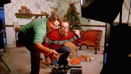 Actors Alexi Morrissey, left, and Patrick Jordan host a live Web broadcast at www.thecommunitree.com from the Strip District. During the broadcast, Internet users are able to remotely control decorate a Christmas tree -- and raise money for Toys for Tots.