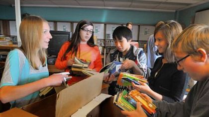 Sorting through boxes of books, are from left, Daria Och, Sarah Berardine, Jackie Nguyen, Ali Marx and Matt Doyle, all freshmen. They were working in the library of Pittsburgh Carmalt Academy of Science & Technology, where the students collected about 1,300 donated books.