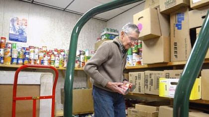 Elmer Brown, 92, of McDonald packs food Thursday at the McDonald Area Food Bank. Borough council recently recognized him for his 30 years of service to the food bank.